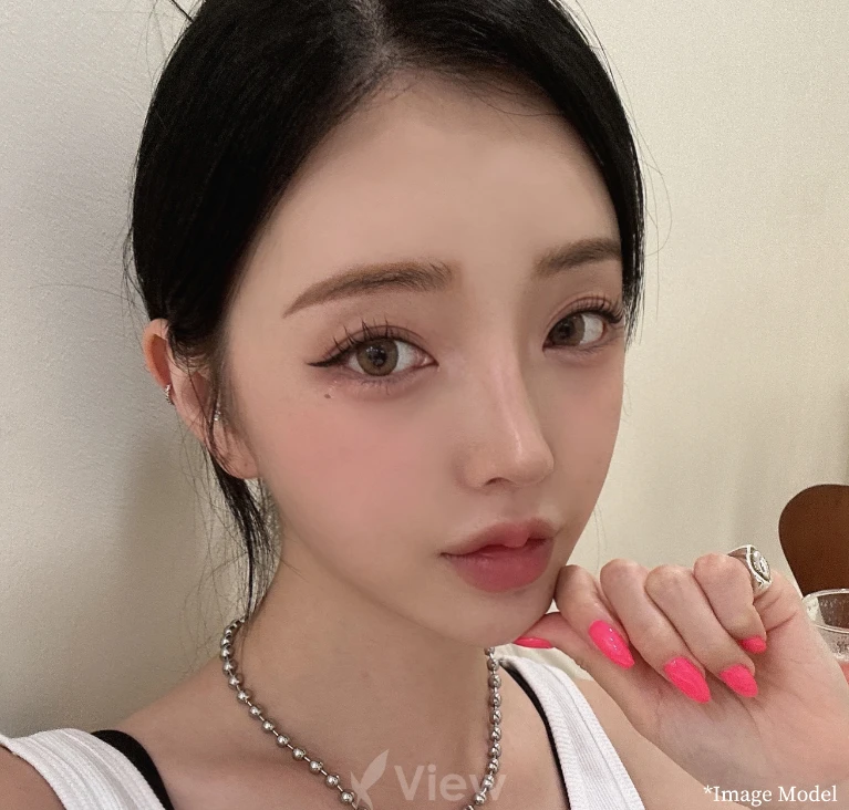 Model portrait highlighting natural facial balance with soft makeup, clear skin texture, and refined facial features.