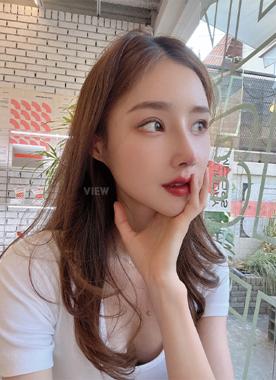 Woman two weeks after receiving rhinoplasty at a Korean plastic surgery clinic